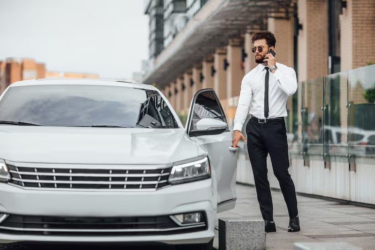 imageye___-_imgi_6_handsome-bearded-businessman-white-shirt-speaking-by-phone-entering-his-car-while-standing-outdoors-streets-city-near-modern-office-center_496169-517